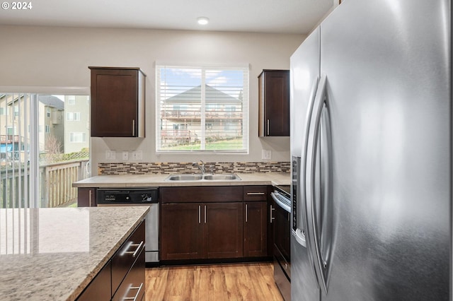 kitchen featuring light wood-type flooring, sink, appliances with stainless steel finishes, and tasteful backsplash