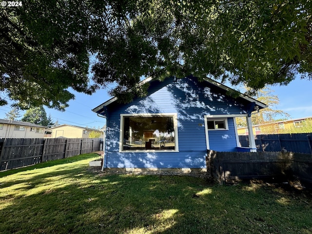 rear view of house with a yard