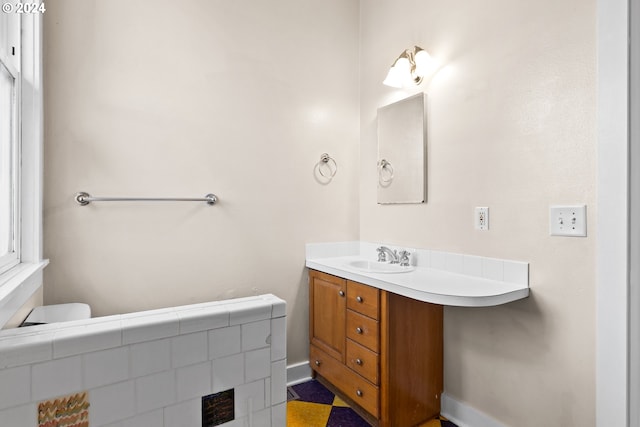 full bathroom featuring vanity, toilet, a textured ceiling, and tiled shower / bath