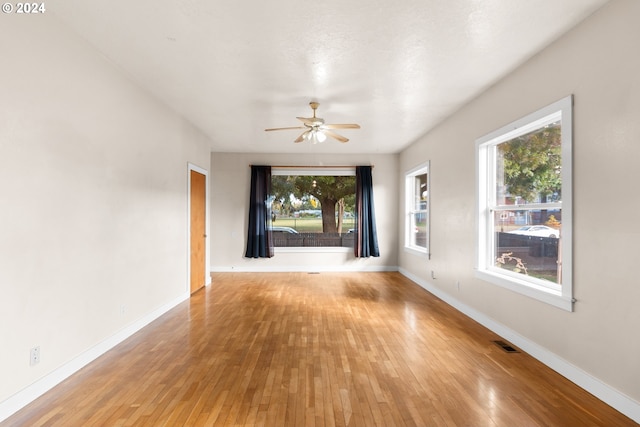 unfurnished living room with a textured ceiling, hardwood / wood-style flooring, and ceiling fan