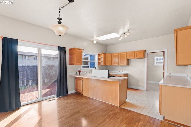 unfurnished living room with ceiling fan, a textured ceiling, and light wood-type flooring