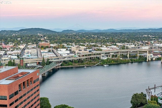 aerial view at dusk with a water and mountain view