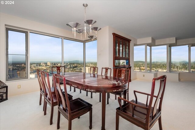 dining room featuring an inviting chandelier and carpet flooring