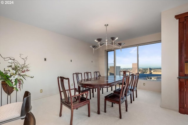 dining area with an inviting chandelier and light carpet