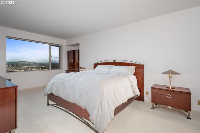 bedroom featuring light carpet