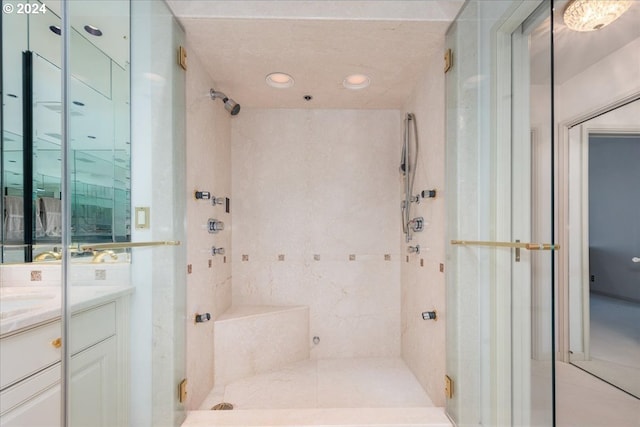 bathroom with walk in shower and vanity