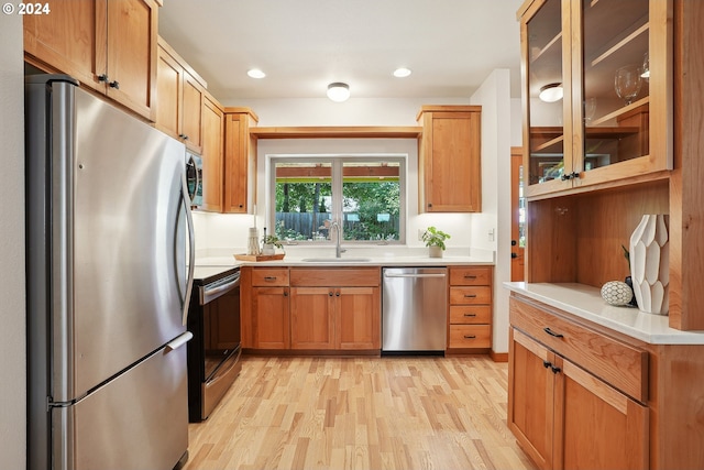 kitchen featuring sink, stainless steel appliances, and light hardwood / wood-style floors