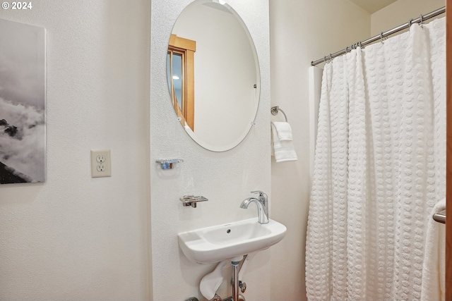 bathroom with sink and a shower with curtain