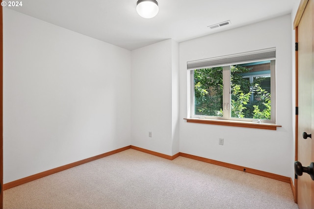 empty room featuring light colored carpet