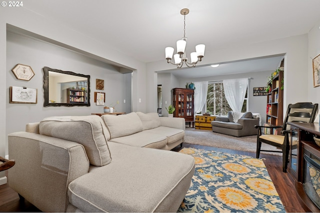 living room with hardwood / wood-style floors and an inviting chandelier