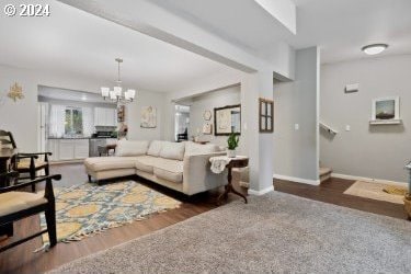 living room with a notable chandelier and hardwood / wood-style flooring