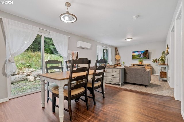 dining space featuring dark wood-type flooring and a wall unit AC