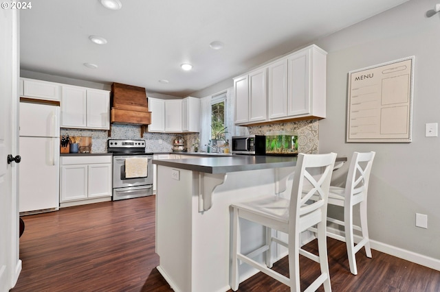 kitchen featuring white cabinetry, stainless steel appliances, and custom range hood