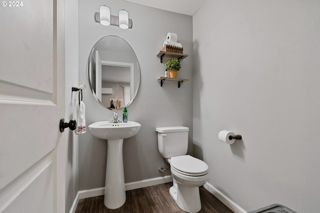 bathroom with toilet and hardwood / wood-style floors