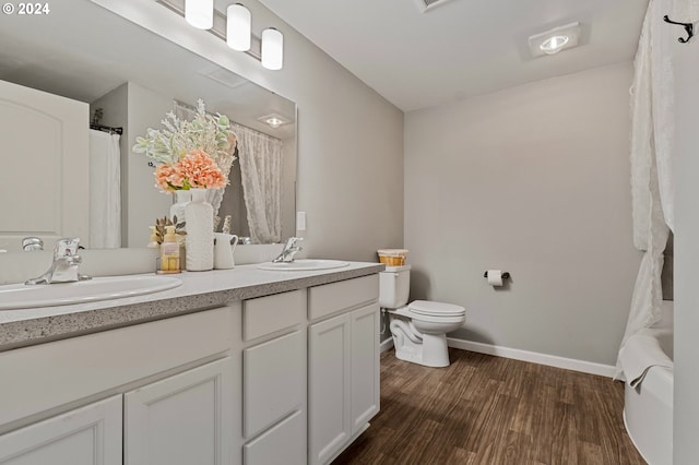 full bathroom featuring vanity, toilet, wood-type flooring, and shower / bath combination with curtain