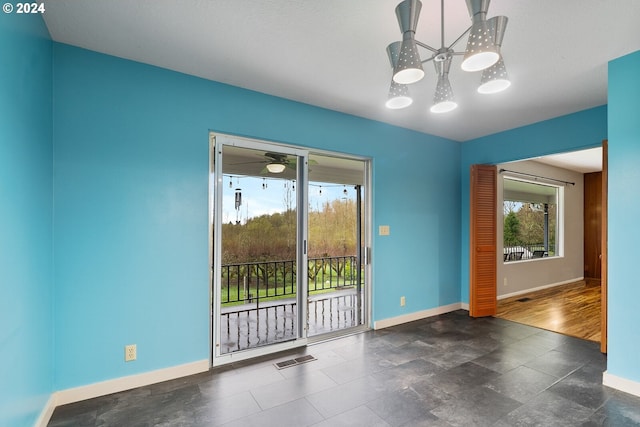 empty room with a chandelier and dark hardwood / wood-style flooring