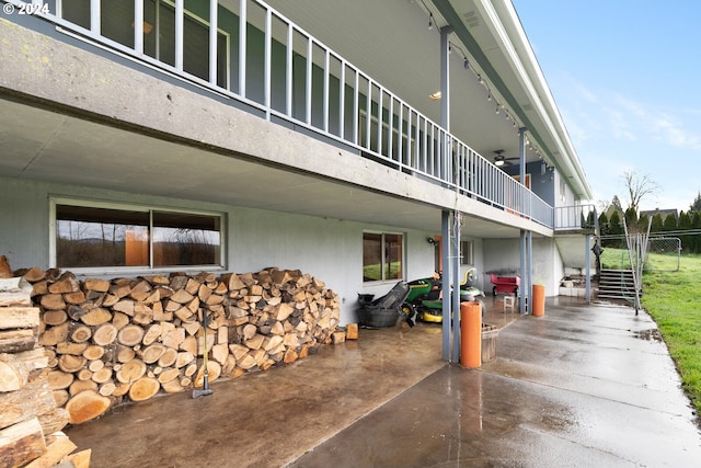 view of property exterior with a patio and a balcony