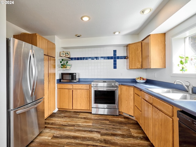 kitchen featuring decorative backsplash, sink, stainless steel appliances, and dark hardwood / wood-style flooring