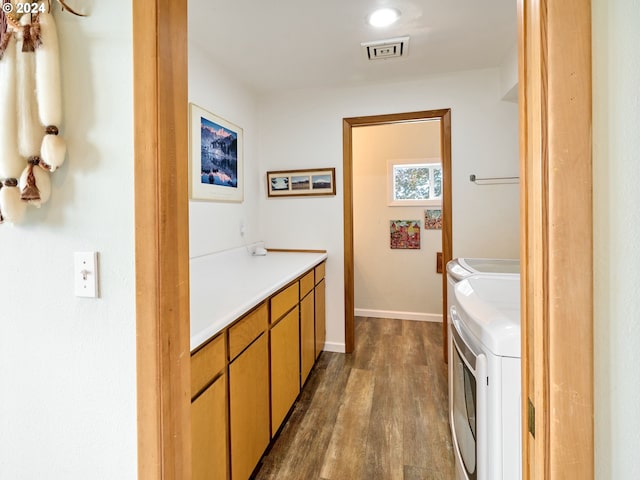 bathroom with washing machine and dryer, vanity, and hardwood / wood-style floors