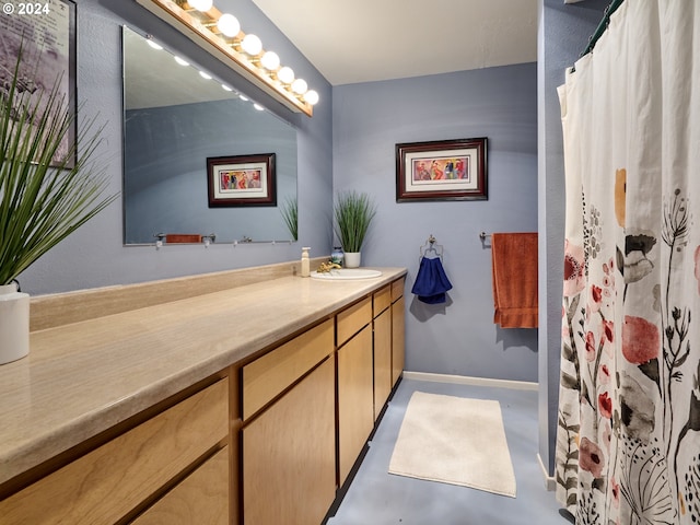 bathroom featuring concrete flooring and vanity