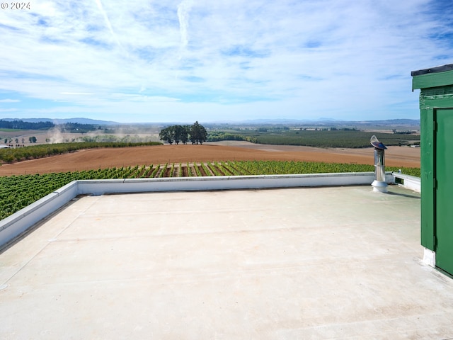 view of patio / terrace with a mountain view and a rural view