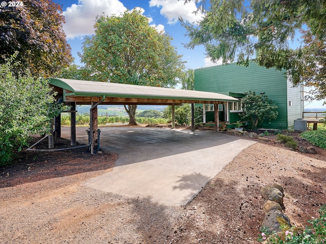 exterior space featuring central AC unit and a carport