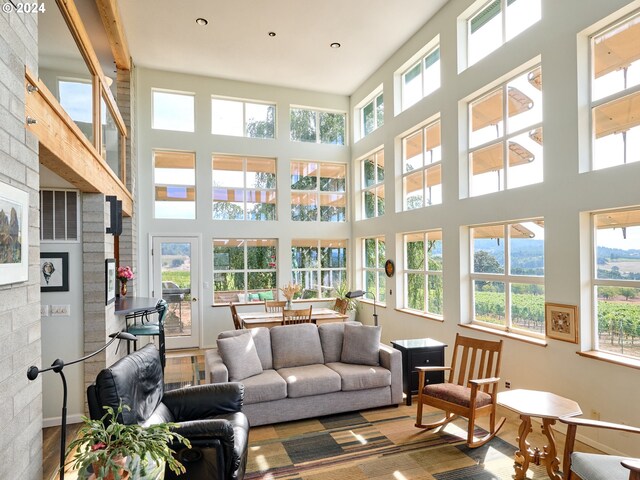 sunroom with beam ceiling and a fireplace