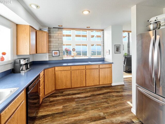 kitchen with stainless steel refrigerator, black dishwasher, and dark hardwood / wood-style floors