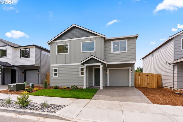 view of front of house with a garage and central AC