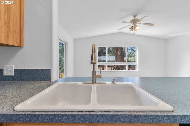 kitchen with sink, vaulted ceiling, and ceiling fan