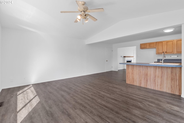 kitchen featuring ceiling fan, vaulted ceiling, sink, and dark hardwood / wood-style floors