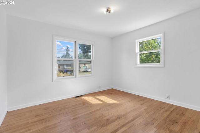 spare room with light hardwood / wood-style floors