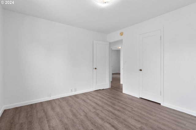 unfurnished bedroom with hardwood / wood-style floors