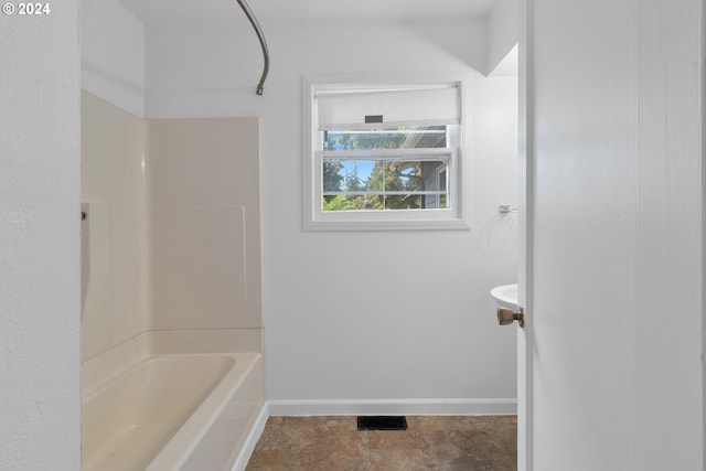 bathroom with tile patterned flooring and shower / tub combination