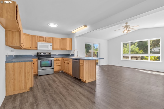 kitchen featuring stainless steel appliances, vaulted ceiling, ceiling fan, kitchen peninsula, and dark wood-type flooring