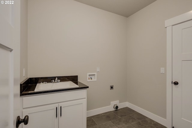 clothes washing area with hookup for an electric dryer, cabinets, hookup for a washing machine, dark tile floors, and sink