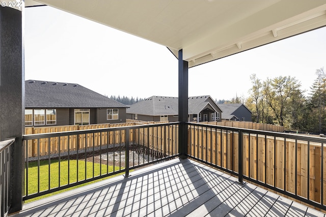 wooden terrace with a lawn