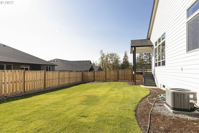 view of yard featuring central air condition unit