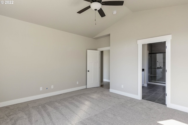 unfurnished bedroom with high vaulted ceiling, connected bathroom, ceiling fan, and dark carpet