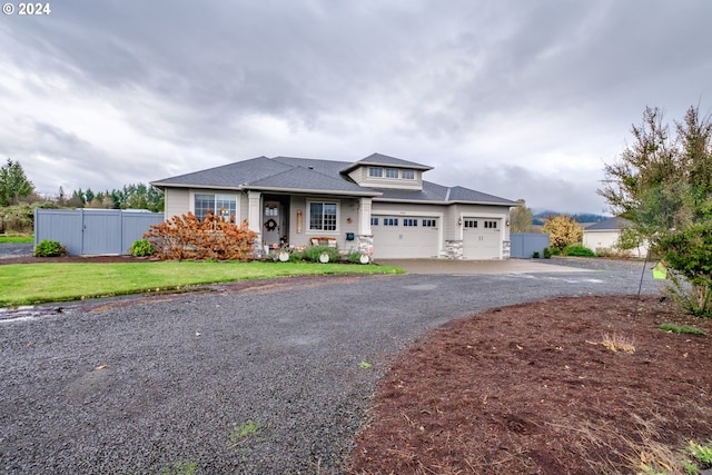 view of front of property featuring a front yard and a garage