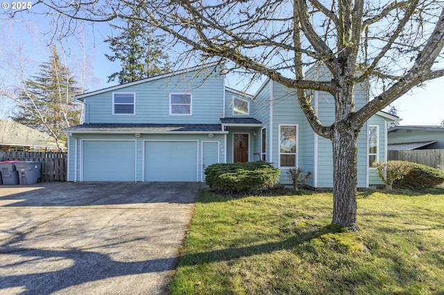 view of property with a garage and a front lawn