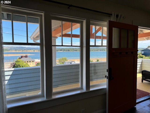 entryway featuring a water view and wood-type flooring