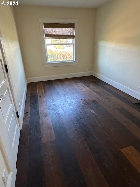 spare room featuring dark hardwood / wood-style floors