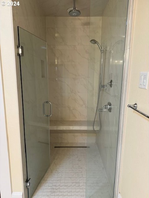 bathroom with tile patterned flooring and walk in shower