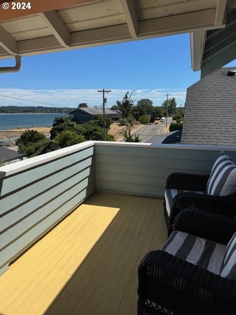 balcony featuring a water view