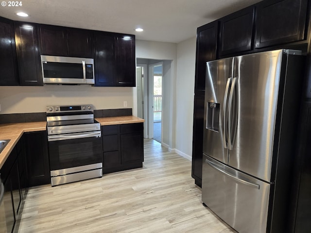 kitchen featuring appliances with stainless steel finishes and light hardwood / wood-style floors