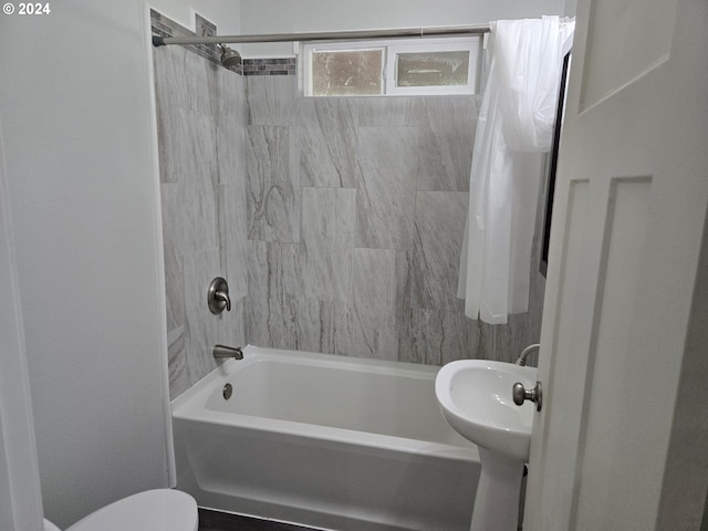 bathroom featuring toilet and shower / bath combo with shower curtain