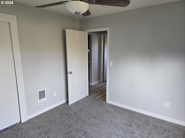 unfurnished bedroom featuring dark carpet and ceiling fan