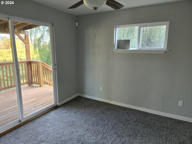 carpeted spare room featuring a healthy amount of sunlight and ceiling fan