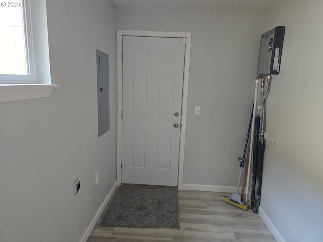 entryway with electric panel and light wood-type flooring